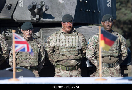 Augustdorf, Germany. 5th Oct 2018. Soldiers wearing camouflage paint standing behind the flags of Great Britain and Germany during a signing ceremony. Defence Minister von der Leyen and her British counterpart signed a 'Joint Vision Statement', a bilateral declaration on closer cooperation in security and defence matters. Photo: Ralf Hirschberger/dpa Credit: dpa picture alliance/Alamy Live News Stock Photo