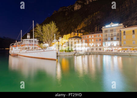 Hotel Europa and moored farry at dusk, Riva del Garda, Garda Lake, Trento province, Trentino Alto Adige, Italy, Europe, Stock Photo