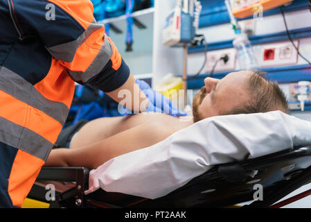 Emergency doctor resuscitate a patient in ambulance. CPR resuscitation. Stock Photo
