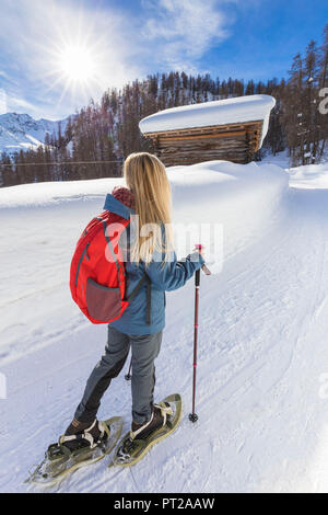 Young girl walk on the snow with snowshoes, Grevasalvas, Engadin Valley, Graubünden, Switzerland, Europe, Stock Photo