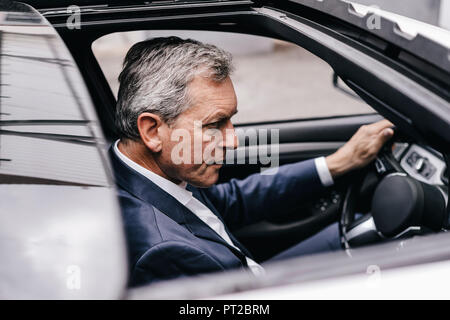 Businessman driving car Stock Photo