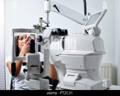 Optician, Young woman during eye test Stock Photo