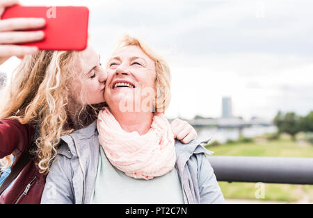 Grandmother and granddaughter taking selfie with smartphone Stock Photo