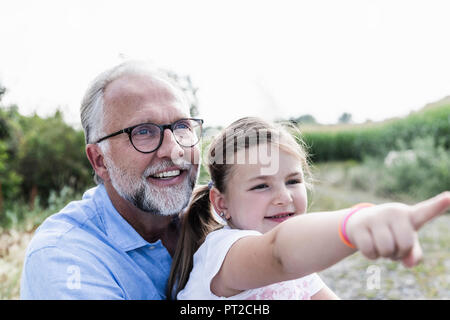 Happy father and daughter having fun, girl pointing Stock Photo