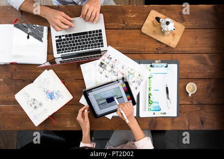 Mature couple working from their home office, using laptop and digital tablet Stock Photo