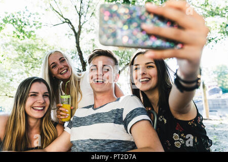 Group of happy friends taking a selfie outdoors Stock Photo