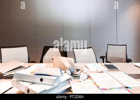 Poland, Warsaw, papers, mini tablet, laptops and folders on conference table at hotel Stock Photo