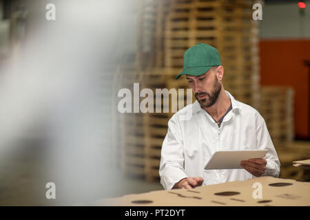 Worker using tablet in factory Stock Photo