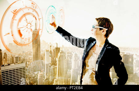 USA, New York City, woman touching transparant projection screen, composite Stock Photo