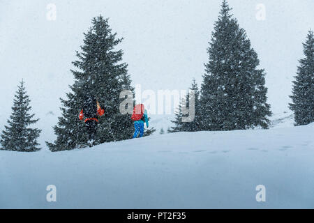 Germany, Bavaria, Walchensee, Einsiedl, snowshoe walker in snowstorm on the way to Simetsberg Stock Photo