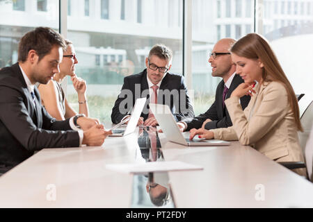 Poland, Warzawa, group of five businessmen having meeting at conference room in hotel Stock Photo