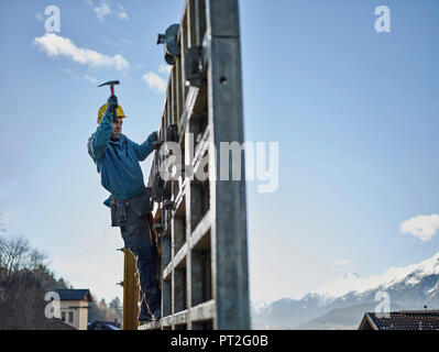 Construction worker working on plywood Stock Photo