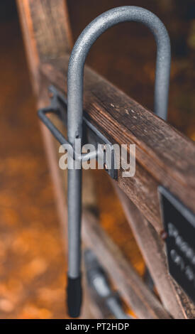 A metal padlock on a wooden gate to keep animals out of a field in Sheffield on a cold autumn day Stock Photo