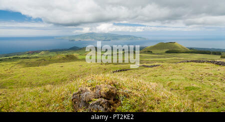 View of Faial from the flank of the volcano Pico, greened volcanic cones in the foreground Stock Photo