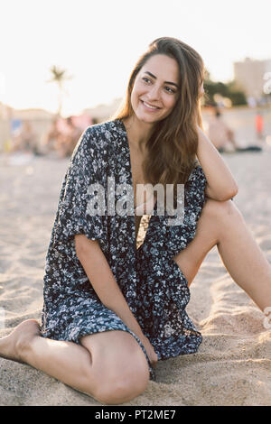 Beautiful woman on the beach at sunset Stock Photo
