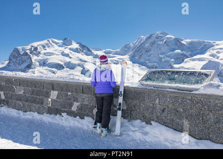 A skier is looking the Monte Rosa Massif from Gornergrat's view point (Zermatt, Canton of Valais, Visp, Switzerlan, Europe) Stock Photo