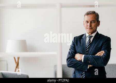 Portrait of mature businessman with arms crossed in his office Stock Photo