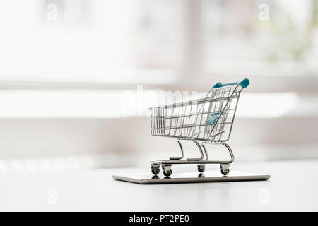 Empty mini shopping cart on tablet Stock Photo