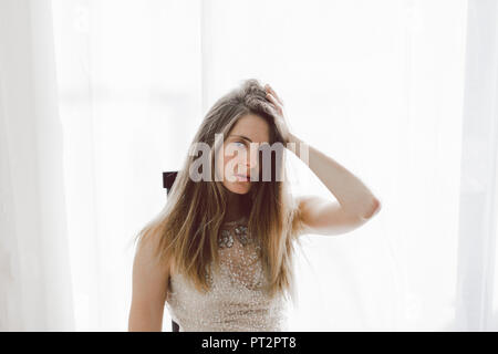 Young woman wearing a wedding dress indoors Stock Photo