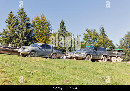 MIKULICZYN, UKRAINE - SEPTEMBER 14, 2018: Tourists take part in adventure extreme tour on quads, SUVs and truck to Carpathian Mountains. It is the sec Stock Photo