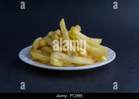 Potato fry or fries on dark background with selective focus and crop fragment Stock Photo