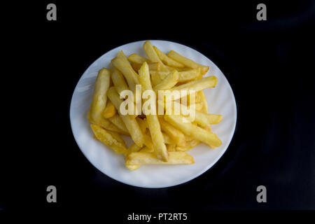 Potato fry or fries on dark background with selective focus and crop fragment Stock Photo