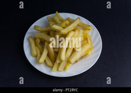 Potato fry or fries on dark background with selective focus and crop fragment Stock Photo