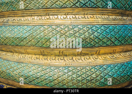 Grungy green stucco pattern of serpent scales for background. Naga scales pattern painted with green and yellow background. Green dragon scales patter Stock Photo