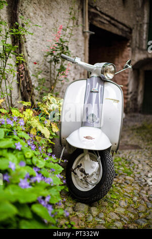 White and grey Lambretta Innocenti scooter in a courtyard