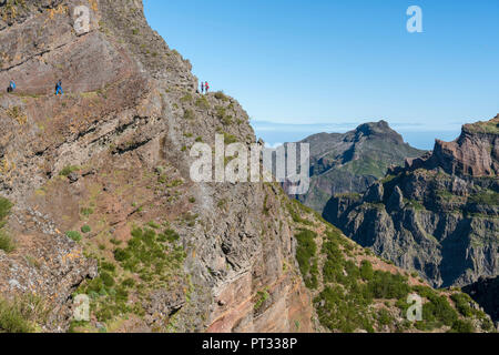 Hikers walking on the trail from Pico Ruivo to Pico do Areeiro, Funchal, Madeira region, Portugal, Stock Photo
