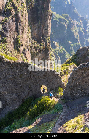 Two people descenging the steps on the trail from Pico Ruivo to Pico do Areeiro, Funchal, Madeira region, Portugal, Stock Photo