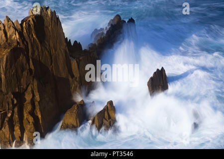 long exposure of ocean surf splashing against rock, Old cabin on Dingle Peninsula, Ireland, Stock Photo