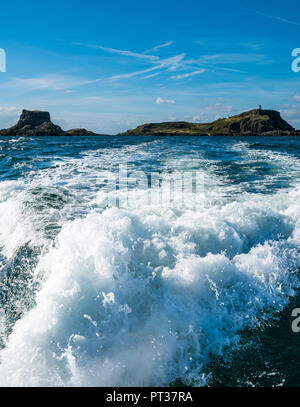 Speeding boat wake and view of Fidra Island, Firth of Forth, East Lothian, Scotland, UK Stock Photo