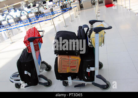 Trolley with suitcases and bags and boxes on the Suvarnabhumi airport, Bangkok, Thailand. Stock Photo