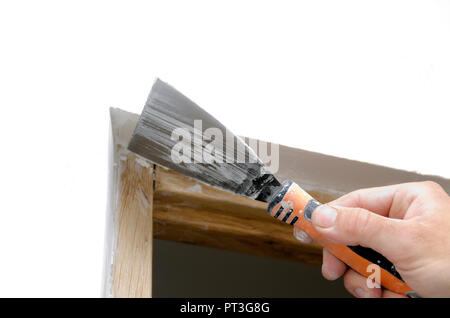mason applying plaster with a spatula Stock Photo