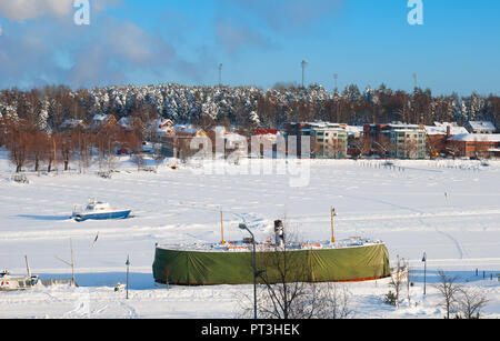 LAPPEENRANTA, FINLAND - FEBRUARY 18, 2010: Winter landscape with boats in harbor on Saimaa Lake. View from Linnoitus Fortress. Stock Photo