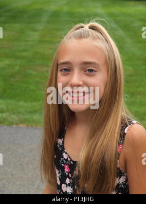 Cute girl eleven years old with blond long hair on white background Stock  Photo - Alamy