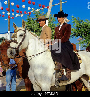 April Fair, Girl on horse dressed in the traditional costume of amazon, Seville, Region of Andalusia, Spain, Europe Stock Photo