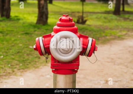 Red fire hydrant on the street in the springtime.Red fire hydrant. Stock Photo