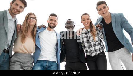 Young and successful team. Four young business people in smart casual wear standing close to each other and smiling discussing Stock Photo