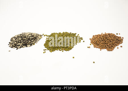 Pile of pulses split black lentil, mung beans, pigeon pea. Isolated on white background. Stock Photo