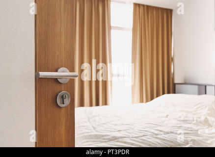 Close-up door opened, entering to bedroom in the morning Stock Photo
