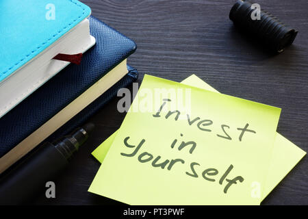 Invest in yourself. Memo sticks and note pads. Stock Photo