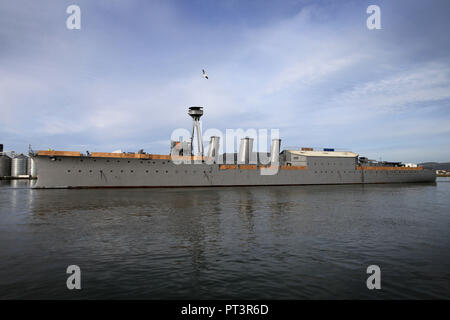 World War One Battle of Jutland veteran light cruiser, the 3,700-ton HMS Caroline is  moved from its current location in Alexandra Dock to Harland and Wolff Heavy Industries’ Belfast Dock for a scheduled hull inspection and repair, Friday, October 28, 2016. Two tug boats towed the ship from its moorings to the Belfast Dock at the mouth of the harbour. This is her first docking for almost three decades and a maritime event to be matched only by her return journey anticipated to be before Christmas. -HMS Caroline is now a proud monument to the 10,000 Irishmen who lost their lives at sea between Stock Photo