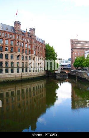 reflecting river in Hamburg in Germany that shows the nearby typical houses of Hamburg Stock Photo