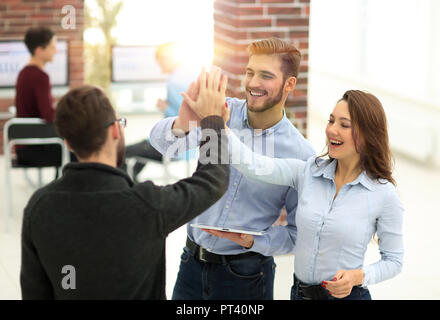 Business and office concept - smiling business team working with tablet pc in office Stock Photo