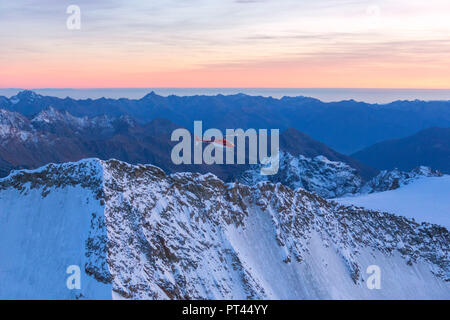 Aerial view of helicopter in flight on peaks of the Bernina Group, border of Italy and Switzerland Stock Photo