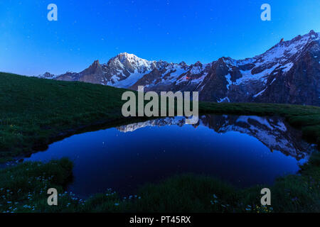 The Mont Blanc is reflected in a puddle during a starry night, Mont de la Saxe, Ferret Valley, Courmayeur, Aosta Valley, Italy, Europe Stock Photo