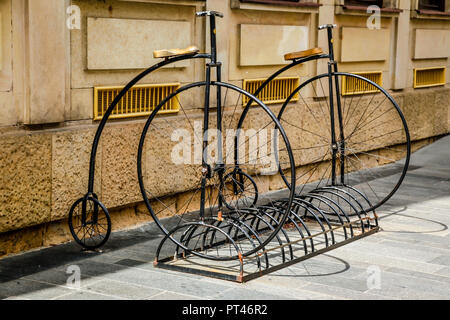 Bicycle rack made up of two penny fathing victorian bicycles Stock Photo
