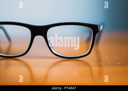 Eyeglasses on wooden table Stock Photo